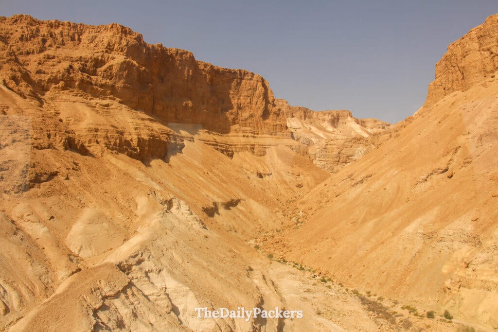 Wide desert landscape view of Masada National Park in Israel with dramatic cliffs and layered rock formations
