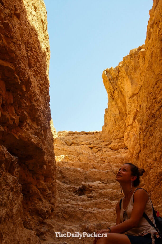 Stone staircase leading down to an ancient water cistern inside Masada fortress, carved into the desert rock
