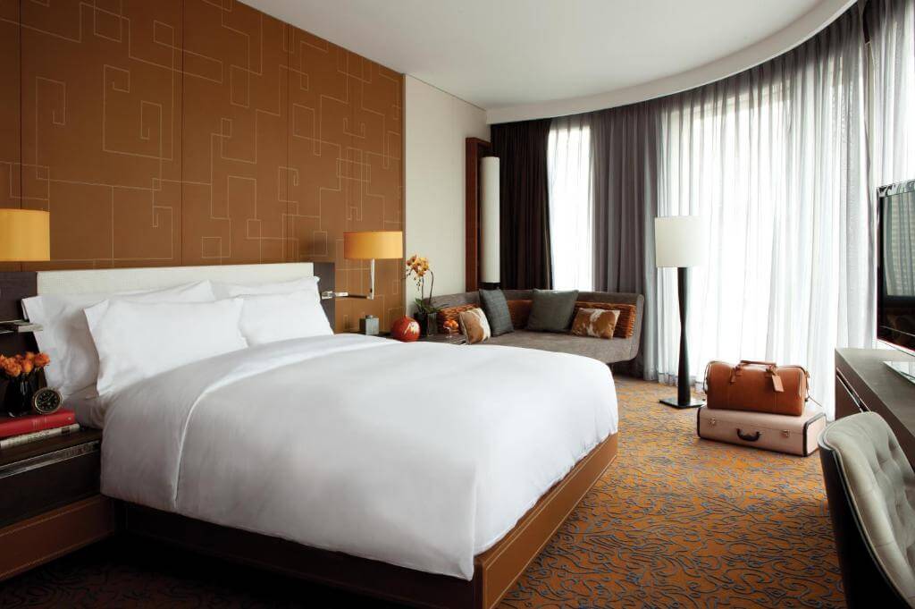 Luxury hotel room at The Langham Shanghai with a king-size bed, modern decor, and elegant city-center ambiance near Xintiandi