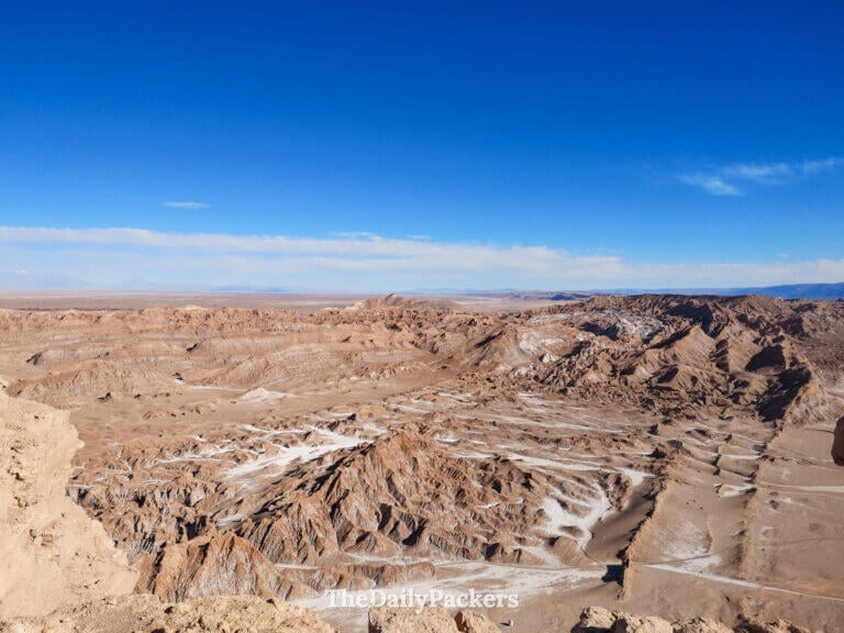 Wide view of Valle de la Luna from the Likan Antay viewpoint, showing dramatic desert ridges, salt streaks, and the endless Atacama horizon.