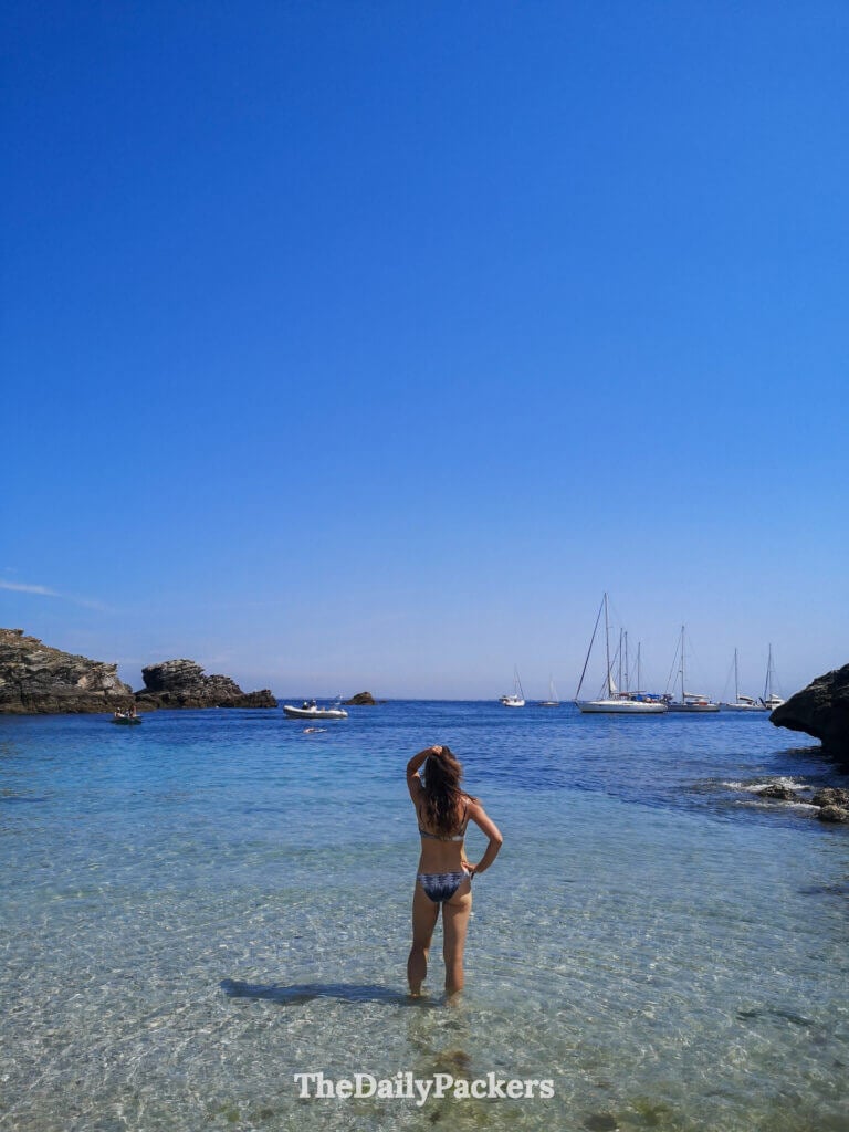 Woman standing in clear water at a secluded beach in Belle Ile en Mer