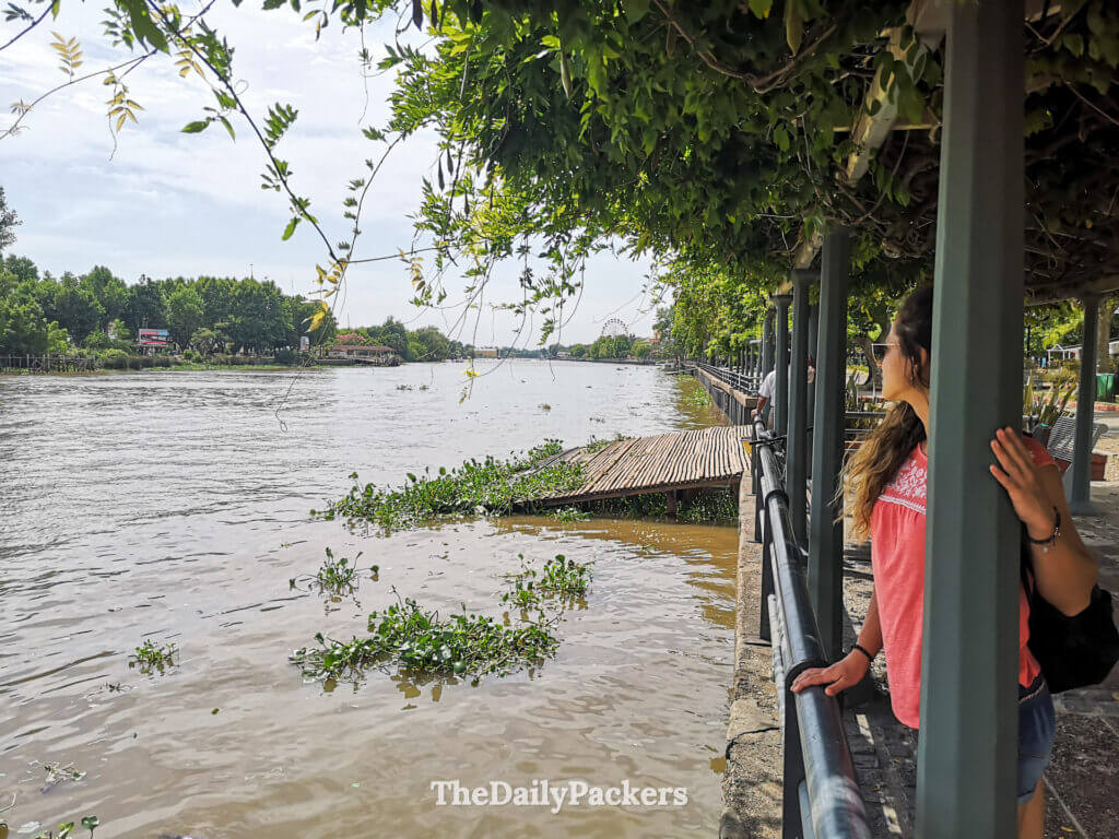 Woman standing on the waterfront near Monumento al Remero in Tigre, Buenos Aires, set on a colorful platform near the river and pedestrian areas.