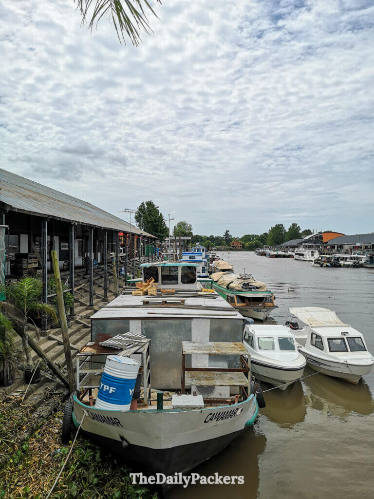 Boats docked beside Puerto de Frutos in Tigre, showing the connection between the market, canals, and delta life.