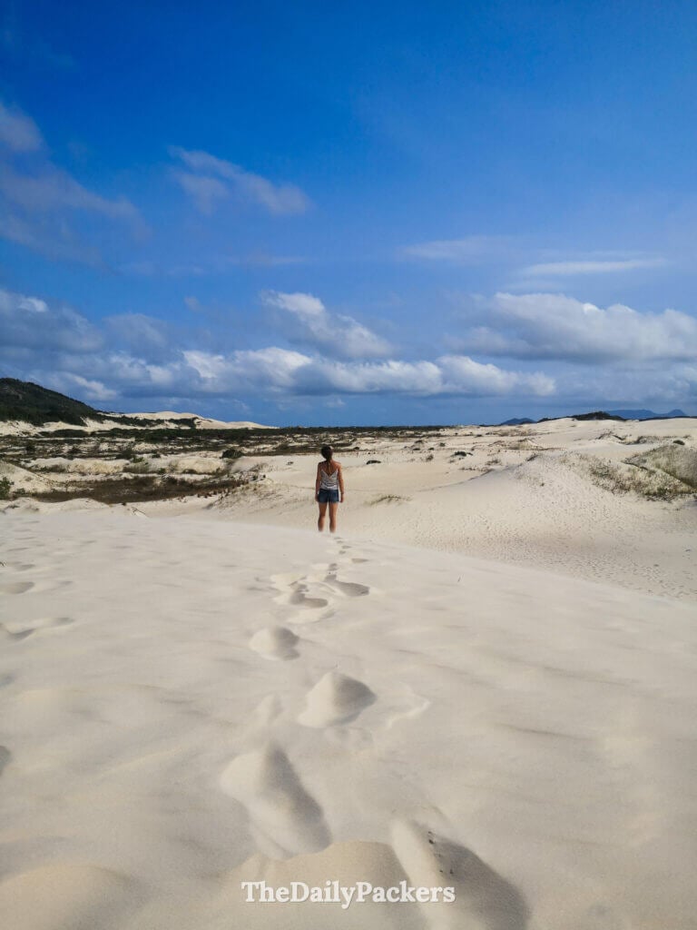 Footprints leading through the expansive sand dunes of Joaquina in Florianópolis, surrounded by untouched dunes and coastal vegetation
