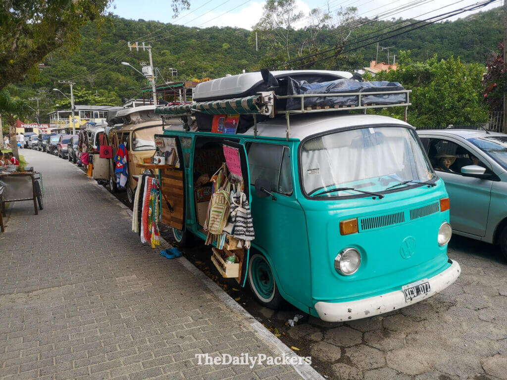 Colorful vintage vans parked along the street at Lagoa da Conceição in Florianópolis, reflecting the area’s surf and van-life culture