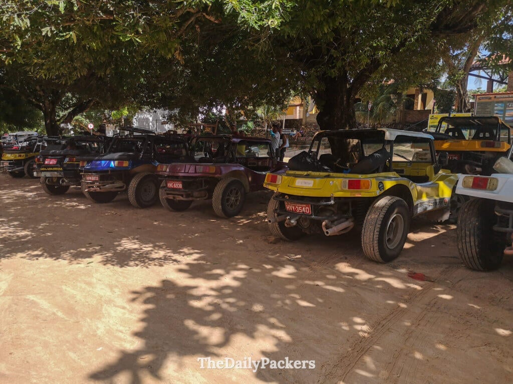 Line of dune buggies parked in Jericoacoara, used for popular 4x4 tours across sand dunes, lagoons, and remote beaches