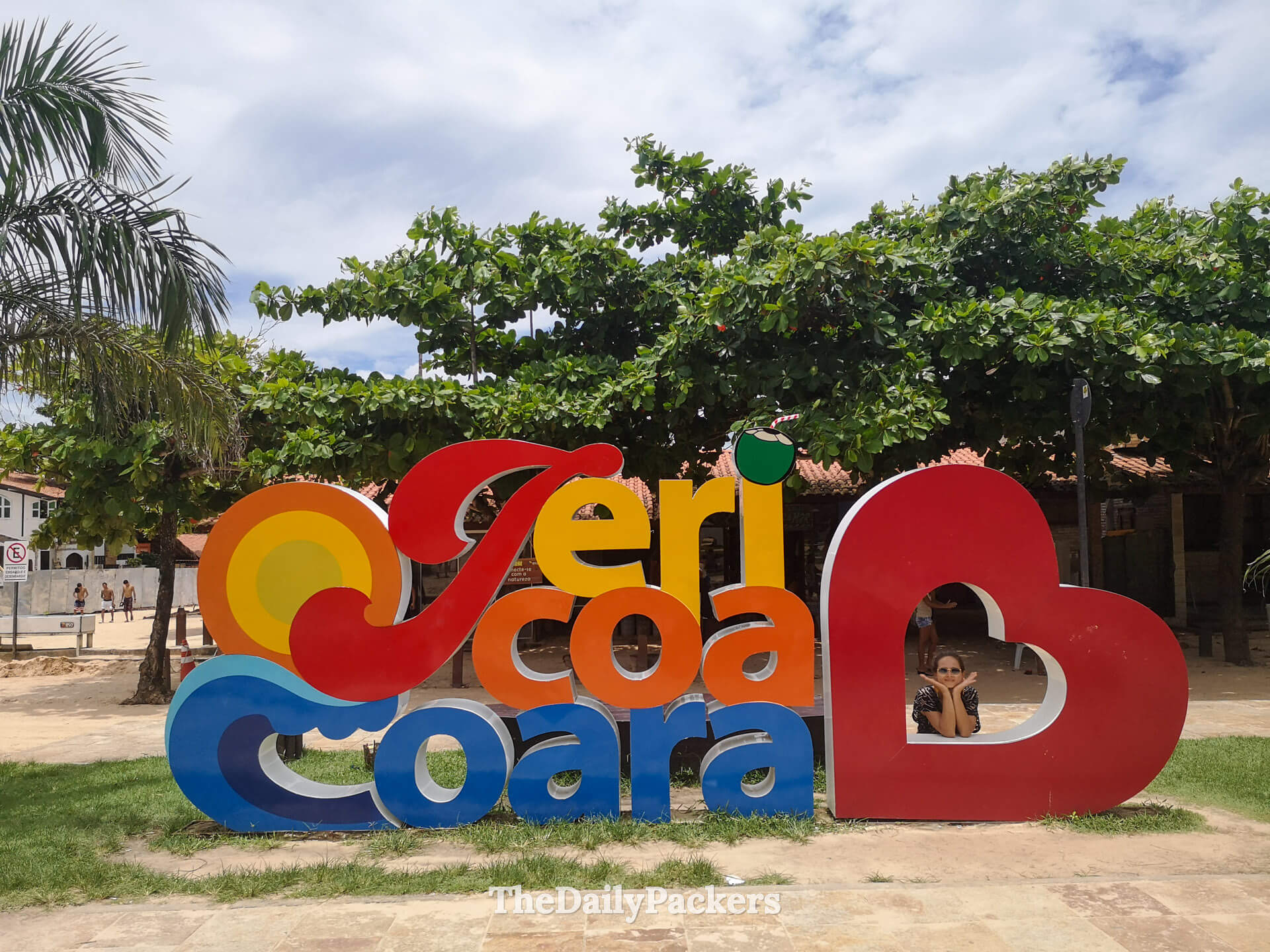 Colorful Jericoacoara village sign surrounded by palm trees, a popular photo spot in Jericoacoara town center