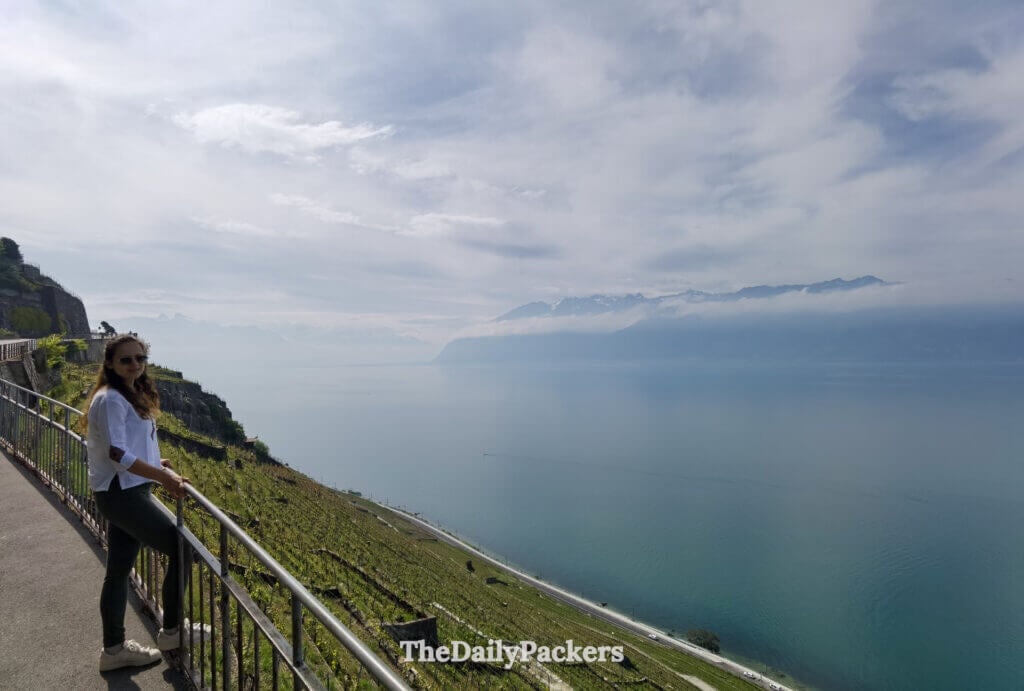 Viewpoint road through Lavaux vineyards with lake and alpine landscape in the distance