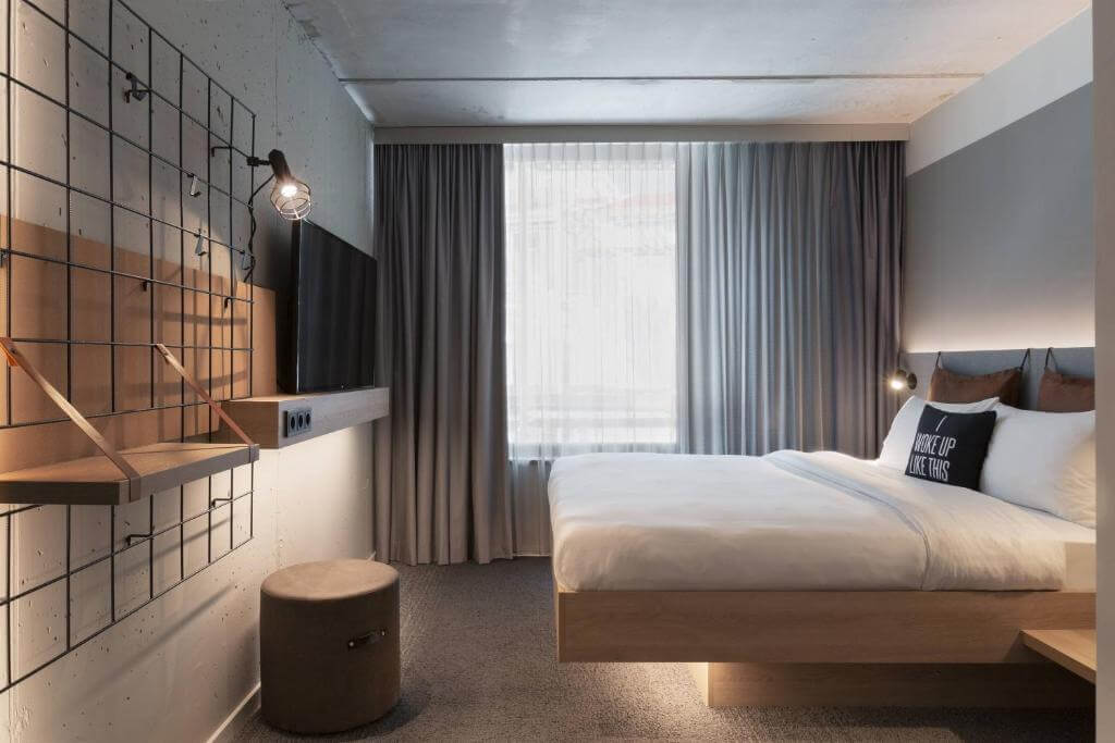 Modern room at Moxy Lausanne City with minimalist design and city-center location