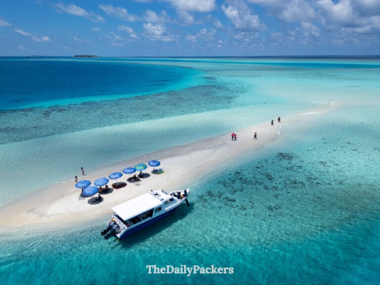 Sandbank tour in the Maldives with boat anchored beside a pristine white beach
