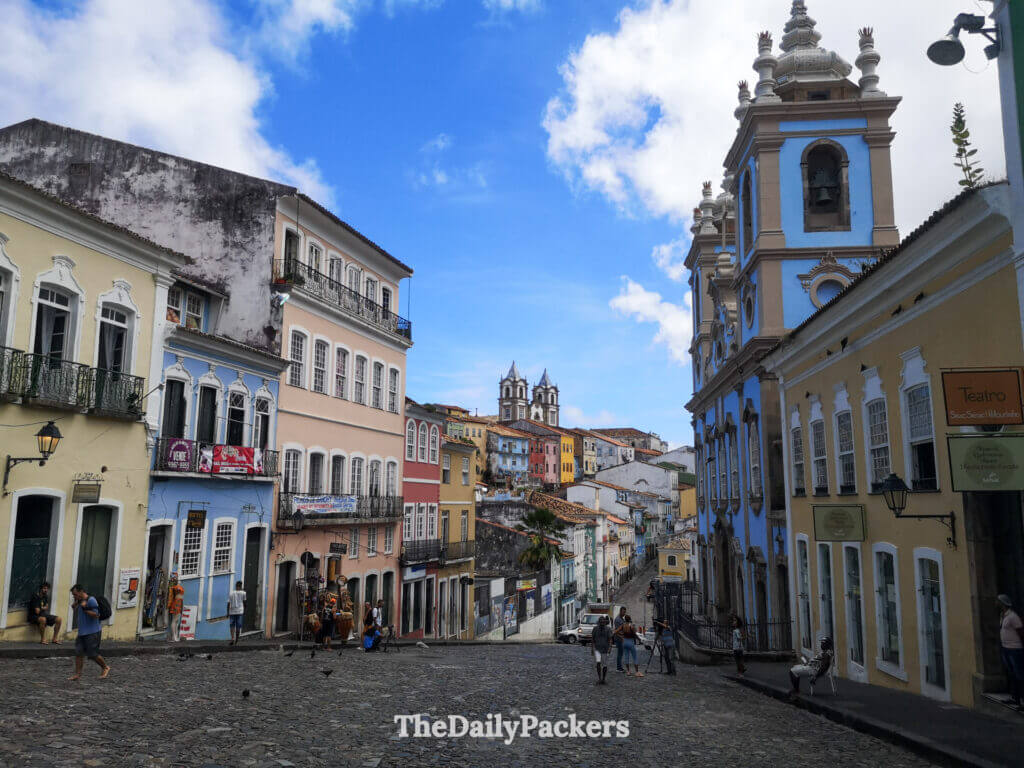 Largo do Pelourinho in Salvador with pastel-colored colonial buildings, cobblestone square, and daily life in the old town