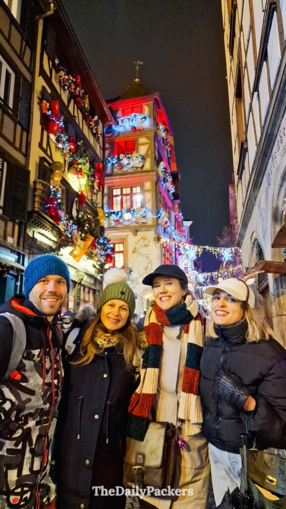 Group of friends in a decorated street near Place Kléber during Strasbourg Christmas market