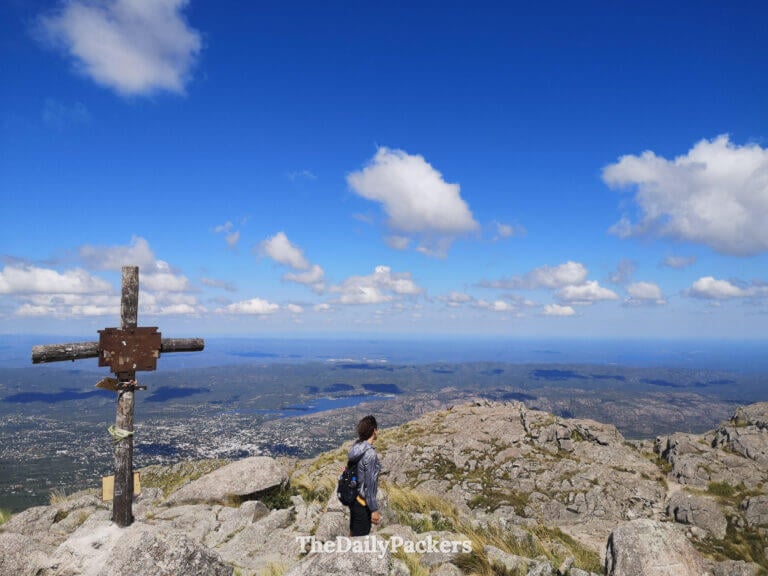 Hiker standing near the summit of Cerro Uritorco overlooking the valley