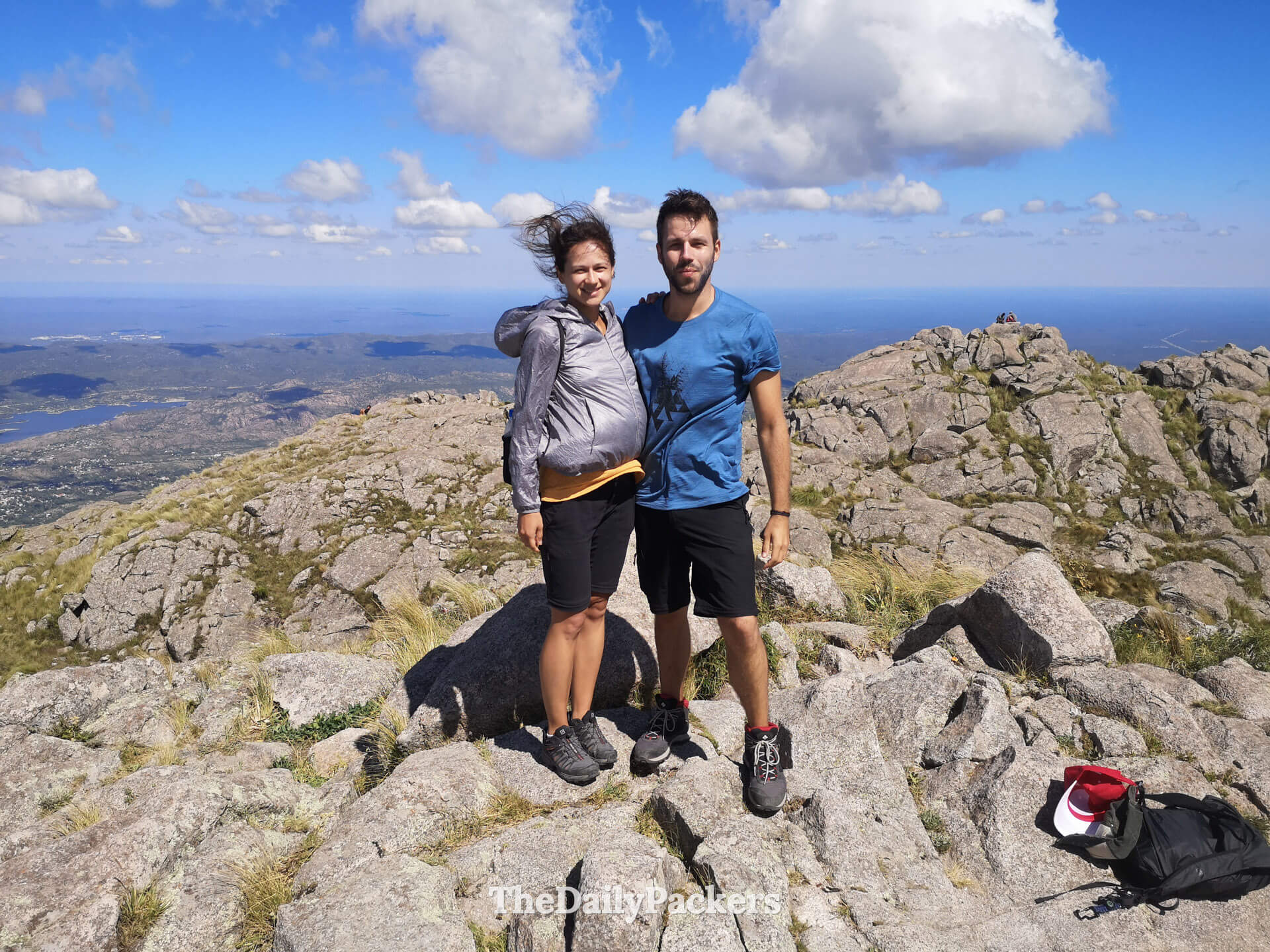Couple at the summit of Cerro Uritorco with sweeping mountain views