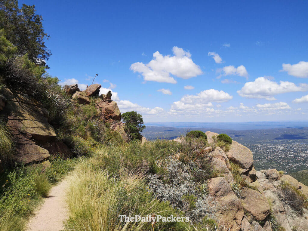 Scenic hiking trail on Cerro Uritorco with rocky cliffs and valley views