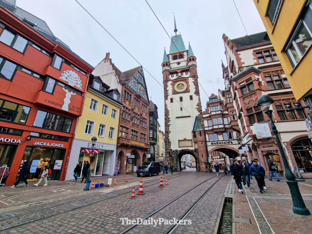 Martinstor medieval gate in Freiburg, colorful old town buildings and tram lines