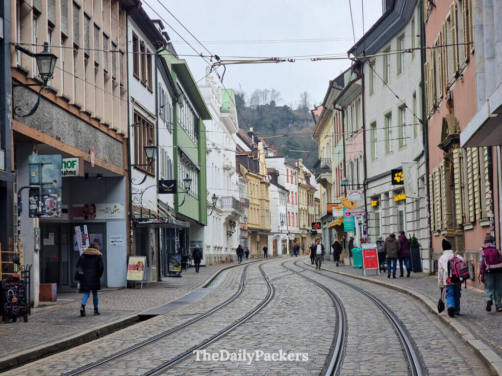 Freiburg Altstadt street with tram tracks and pastel historic buildings