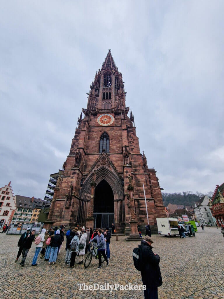 Front view of Freiburg Minster with main entrance and iconic Gothic tower