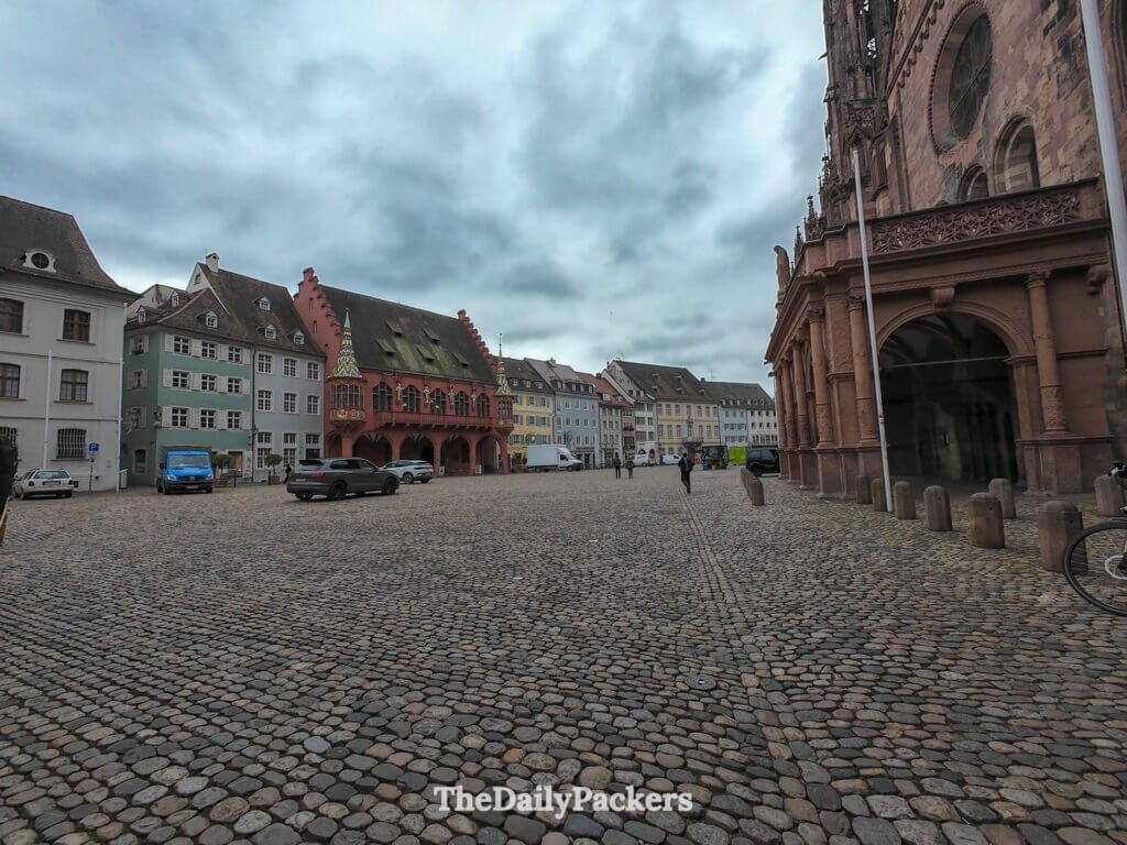 Münsterplatz in Freiburg with cathedral arcade and colorful historic houses