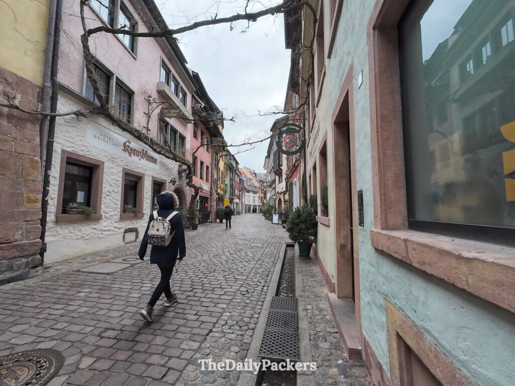 Quiet cobblestone street in Freiburg old town with Bächle canal