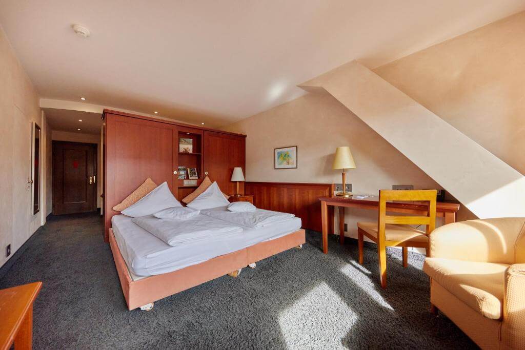 Spacious room at Hotel Zum Roten Bären in Freiburg, classic decor and work desk
