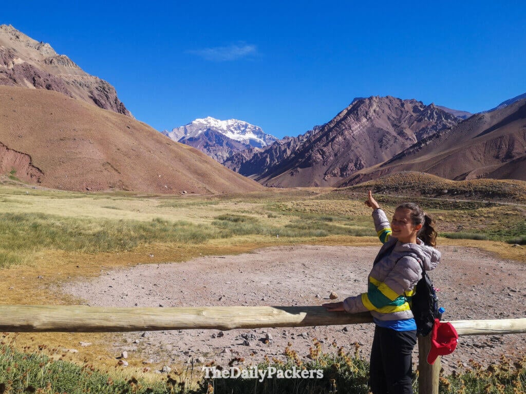 Hiker pointing toward Mount Aconcagua near Horcones Valley in Argentina
