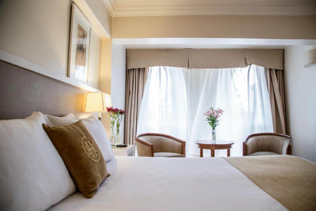 Comfortable hotel room at Huentala Hotel in central Mendoza with seating area