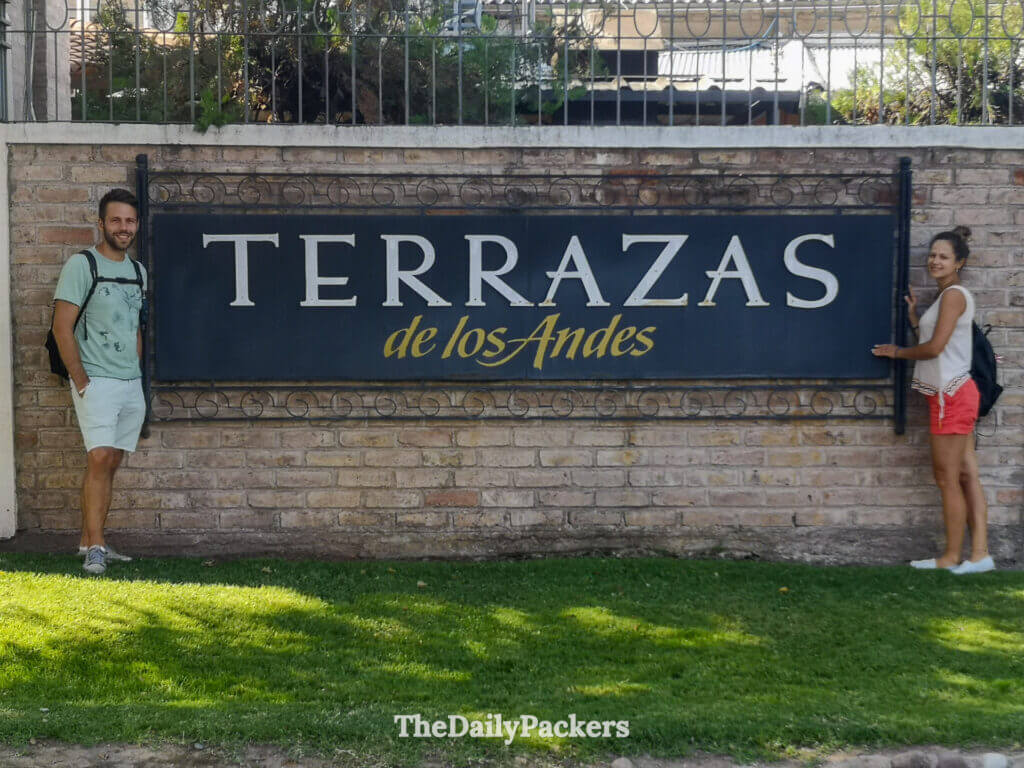 Couple posant près du panneau de l’établissement vinicole Terrazas de los Andes à Mendoza, Argentine