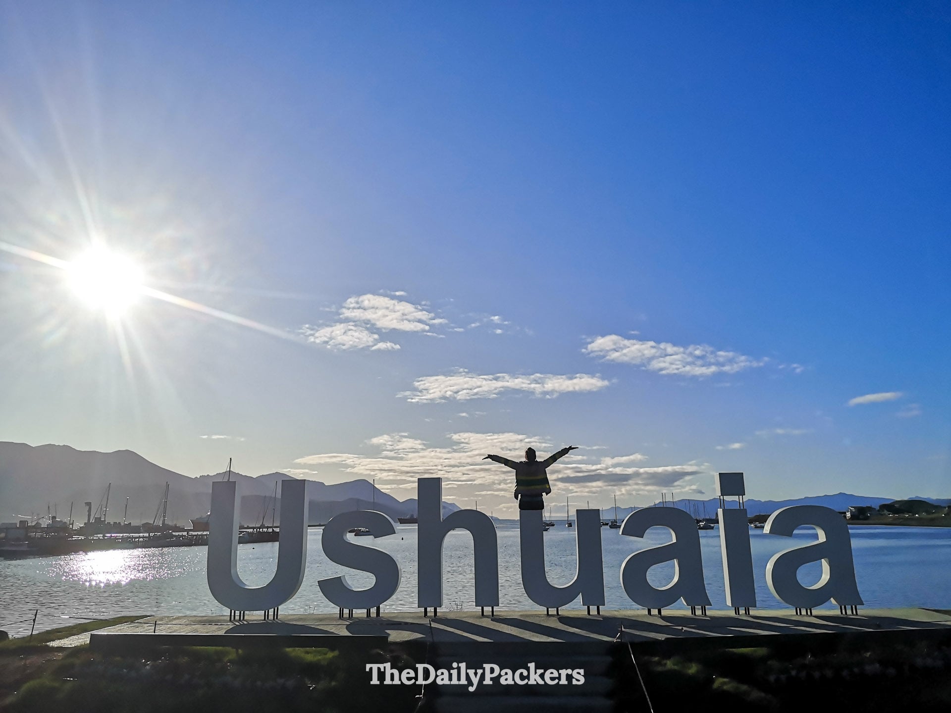 Ushuaia waterfront letters with mountains and harbor