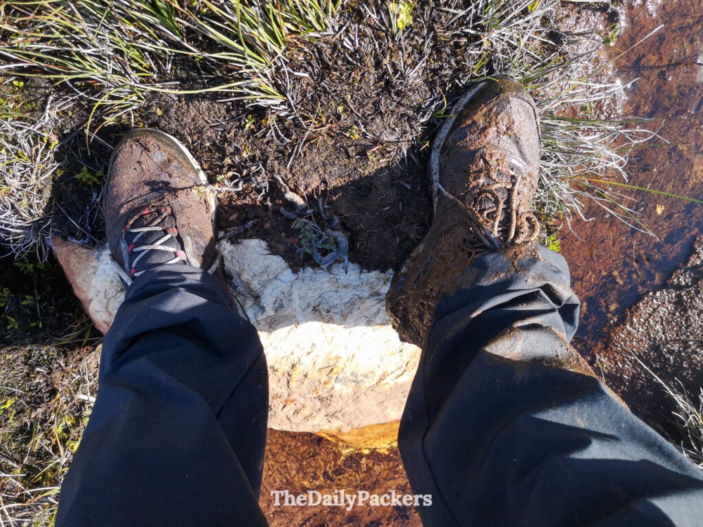 Mud covered hiking boots on Laguna Esmeralda trail