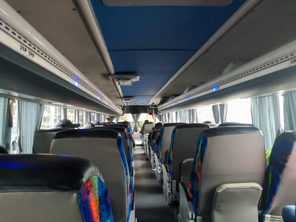 Front section of LEP bus interior with driver area and passeners during travel