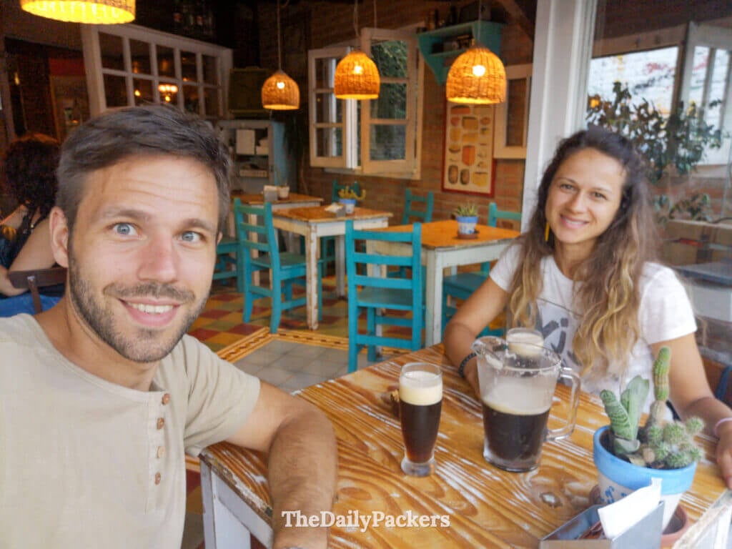 Couple enjoying craft beer inside a cozy café in Villa General Belgrano, Argentina
