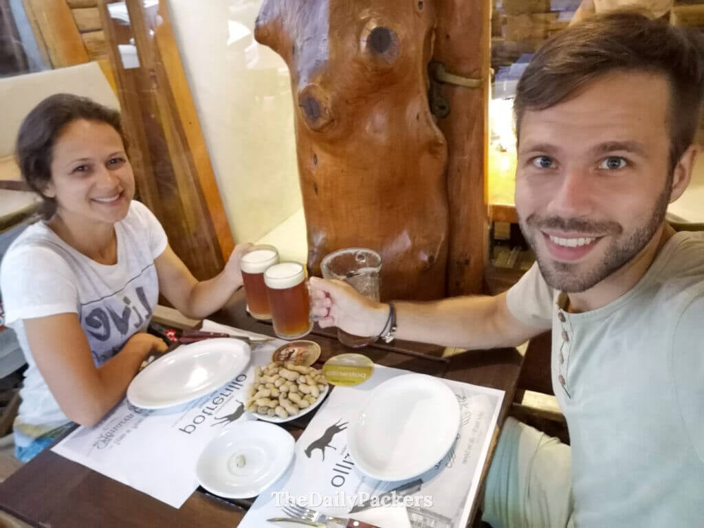 Couple enjoying local beer at a traditional restaurant in Villa General Belgrano