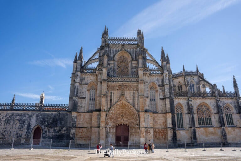 A close-up view of the majestic carved stone archway at the entrance to Batalha monatery church