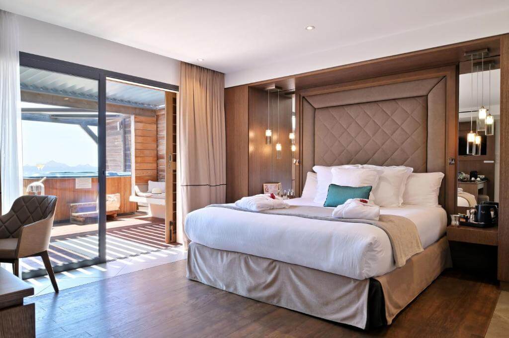 Luxury room at Hotel Le Week-End overlooking the turquoise waters of the Gulf of Ajaccio and the rugged Corsican coastline.