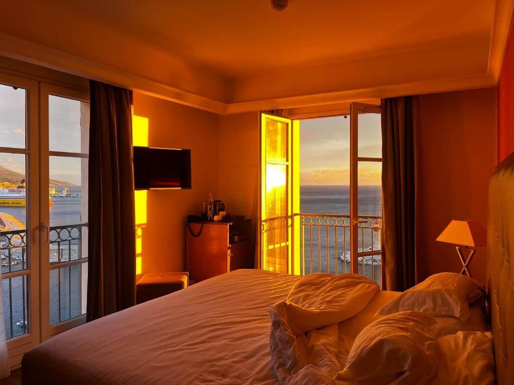 A luxury room at Hôtel Des Gouverneurs in Bastia, overlooking the historic old port and the sea