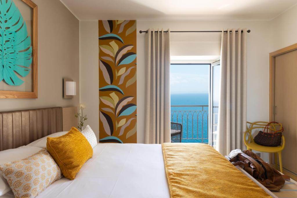 A cozy and elegant bedroom at Hotel Santa Teresa in Bonifacio, one of the Best Hotels in Corsica