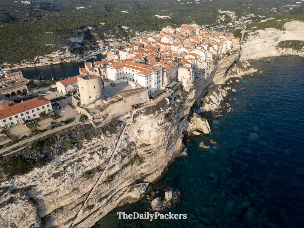 Drone perspective of the citadel and steep cliffs overlooking the sea in Bonifacio.
