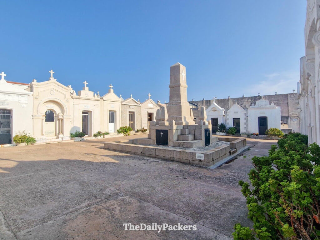 Historic marine cemetery with white mausoleums under a blue sky in Bonifacio.