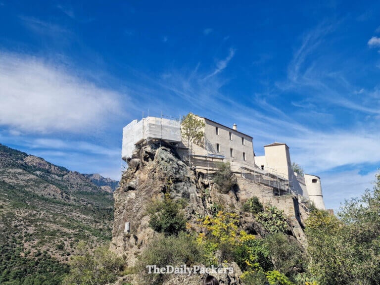 The iconic Eagle's Nest tower of the Citadel of Corte overlooking the valley.