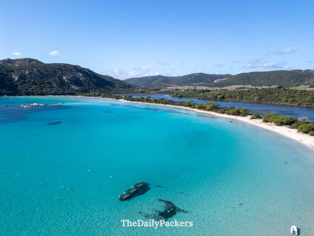 Drone view of turquoise waters and white sand at Santa Giulia Beach in Porto-Vecchio, Corsica.