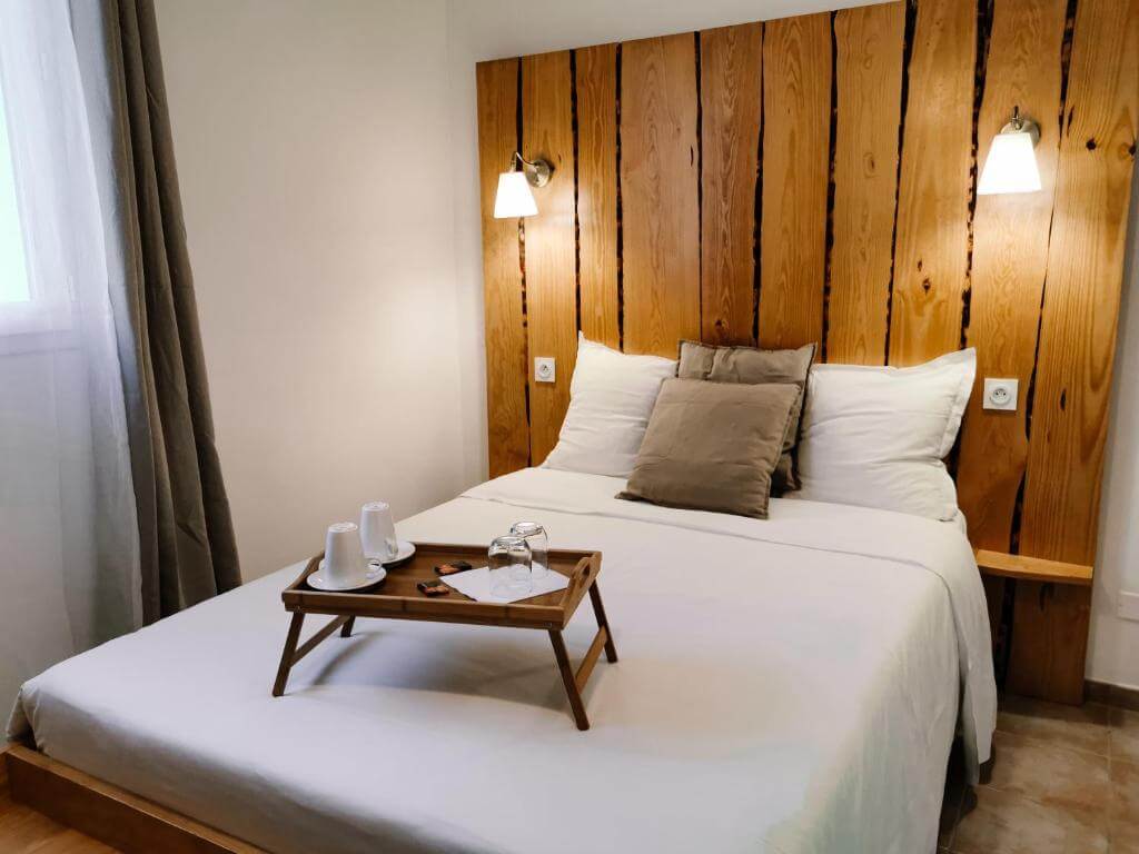 Bright and spacious bedroom at Maison San Giovanni in Corte featuring traditional Corsican stone walls and elegant decor.