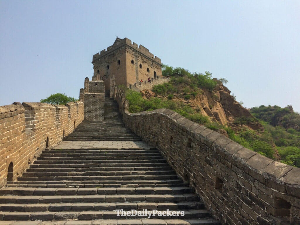Wide-angle view of ancient stone steps climbing to a watchtower at Jinshanling Great Wall, Hebei