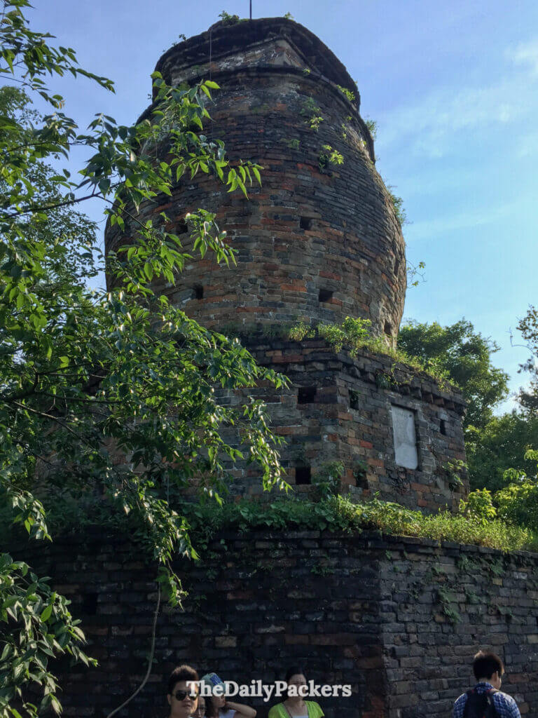Ancient brick pagoda ruins overgrown with greenery at Xiangshan Scenic Area, Guilin.
