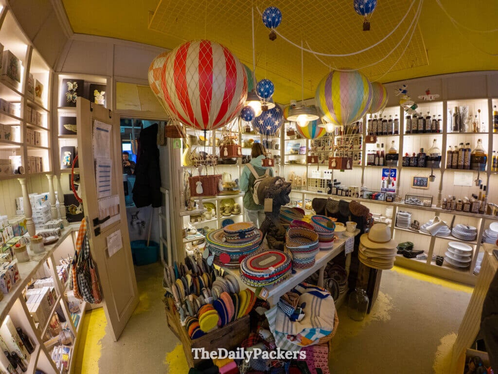 Whimsical interior of an Óbidos gift shop featuring hanging hot air balloon models.