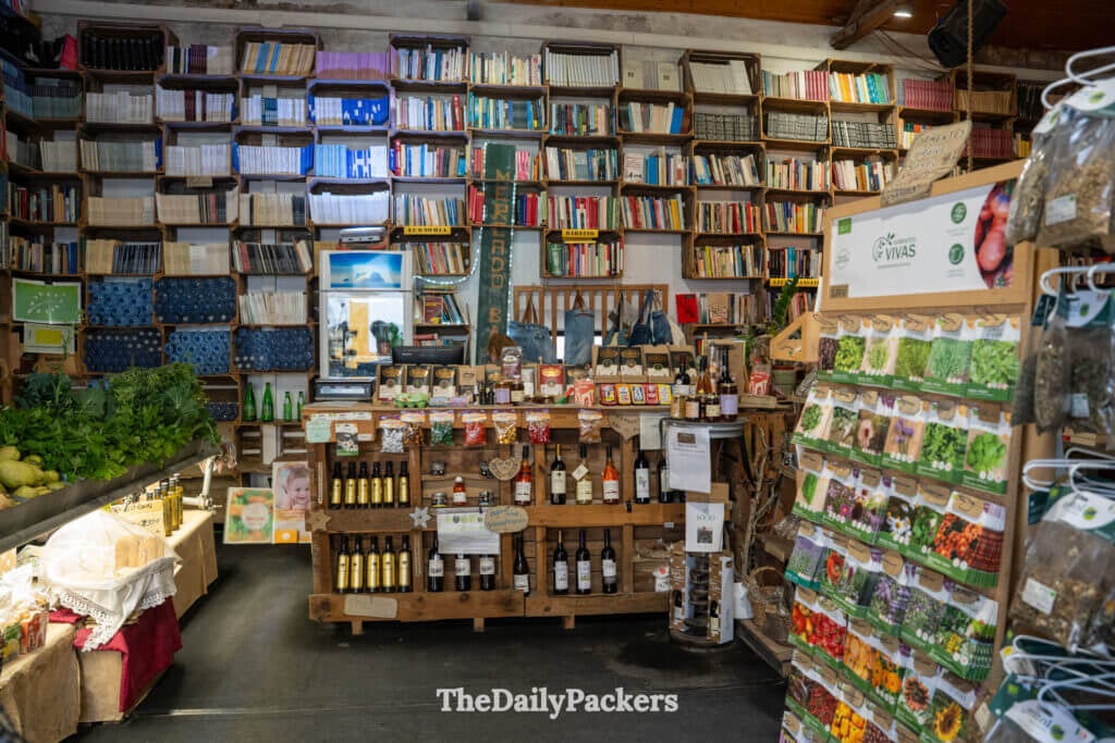 Organic produce and local wine displayed among book-lined walls at Mercado Biológico.