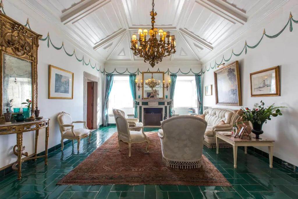 Elegant, classic guest lounge inside Casa Picva guesthouse featuring a large glass chandelier.