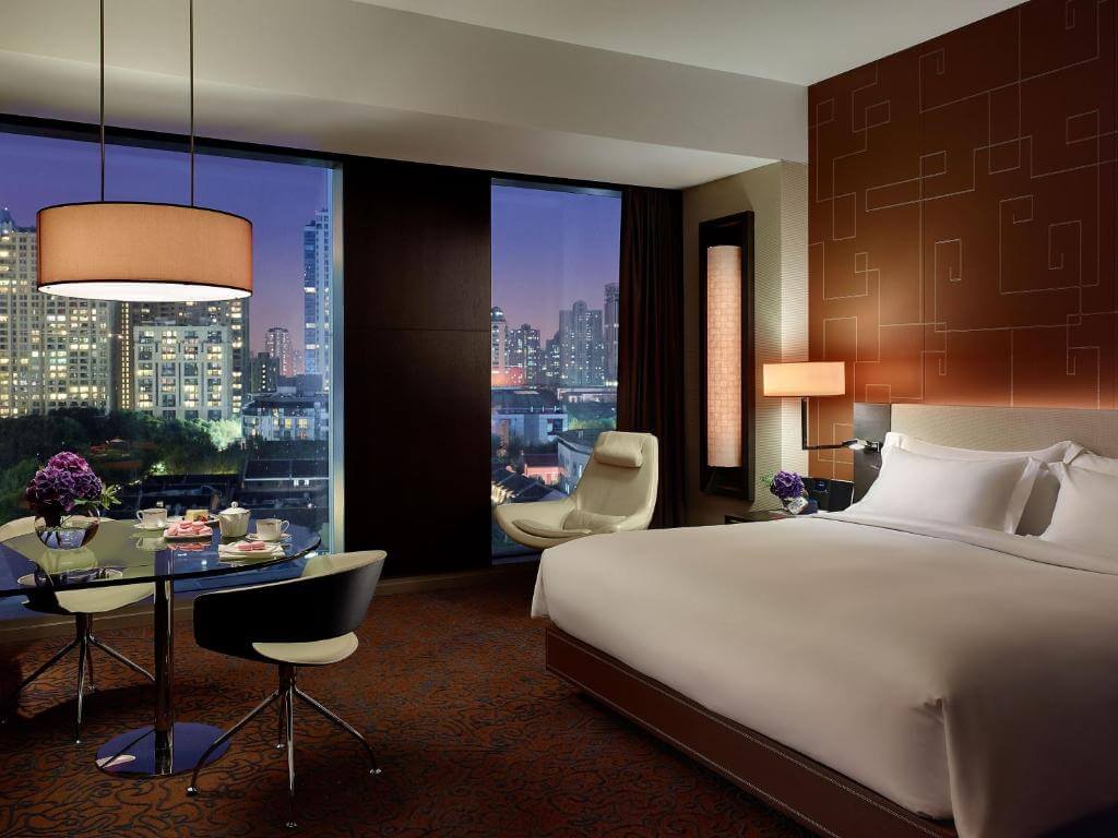 Elegant king room at The Langham Xintiandi with panoramic night views over Shanghai rooftops