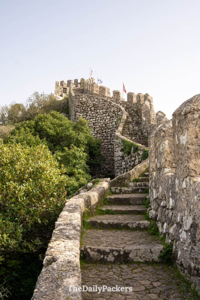 Stone steps lead up the fortified battlements of the Castle of the Moors under a clear sky.