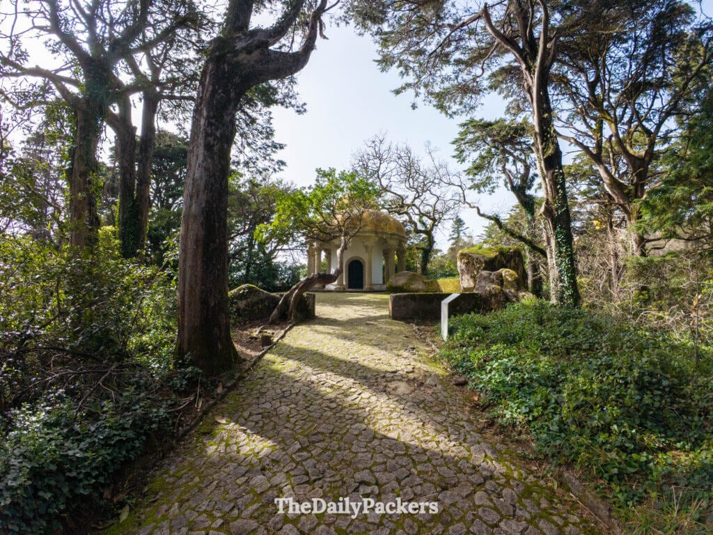 Cobblestone path leading to the Temple of Columns structure in Pena Park, Sintra.